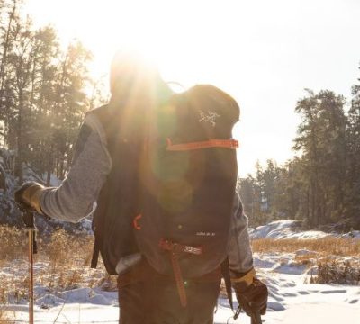 Image of a person facing away from the camera as the enjoy snowshoeing in the Whiteshell Provincial Park, Manitoba.