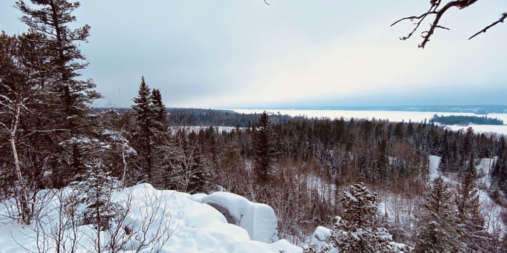 Image shows a snowy lookout point at Top of the World Trail.